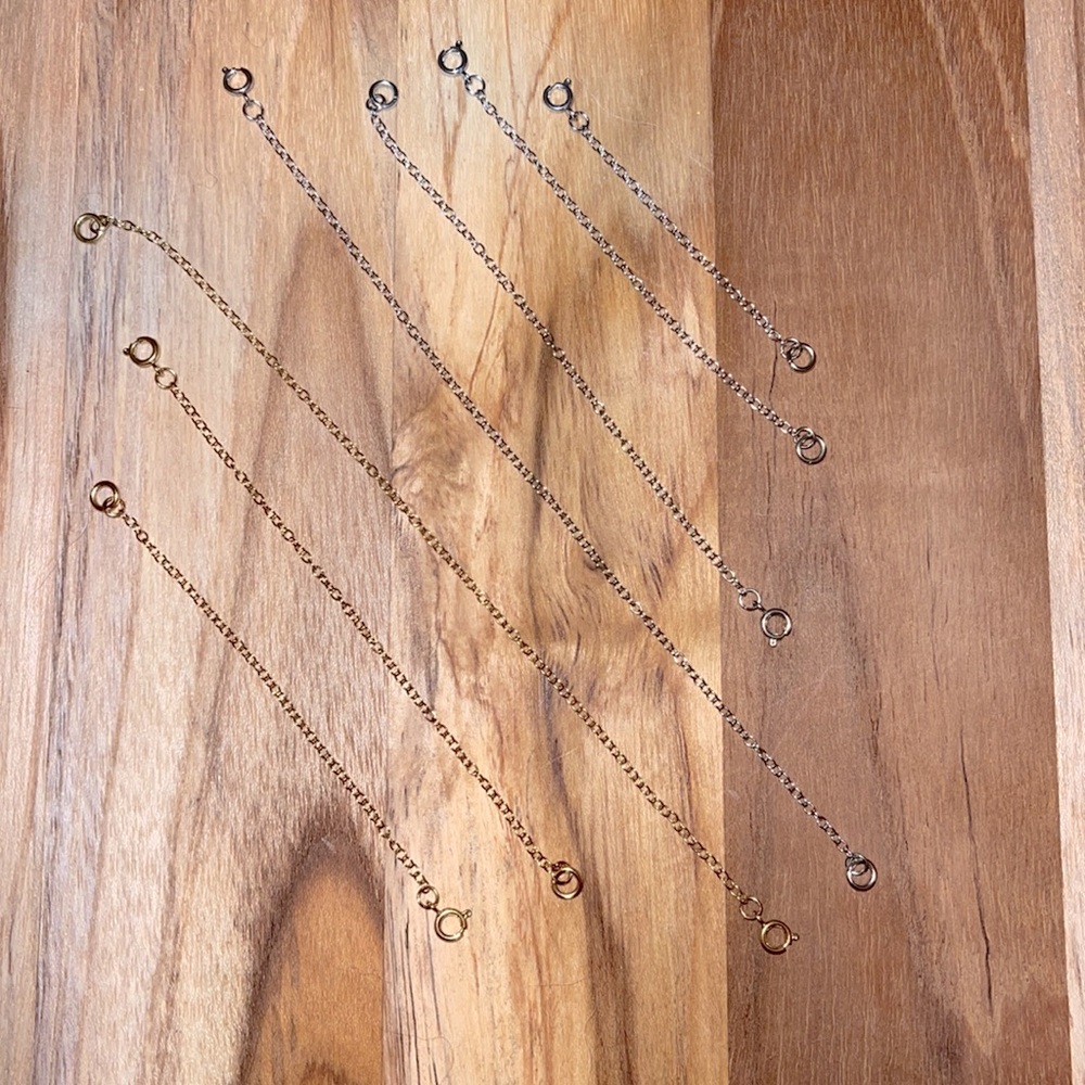 Various length silver and gold necklace extenders